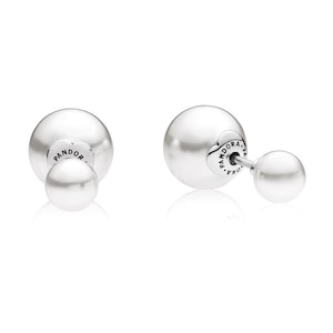 May include: A pair of silver-coloured double-sided stud earrings. Each earring has a large, smooth, round ball at the front and a smaller ball at the back. The brand name "Pandora" is visible on the back of the earrings.
