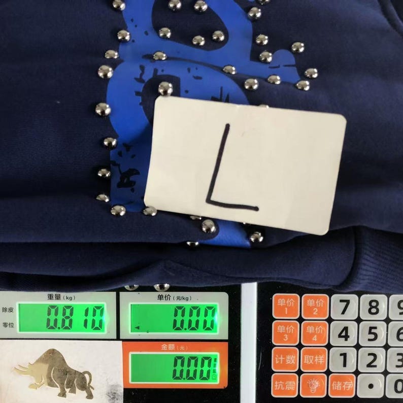 May include: Navy blue sweatshirt with silver studs and a large blue design. A white tag with a black "L" is attached. The weight is 0.810 kg.