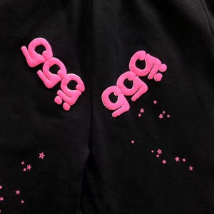 May include: A white ceramic mug with a black handle and the text "But First, Coffee" in a black, bold font. The mug is on a white surface.