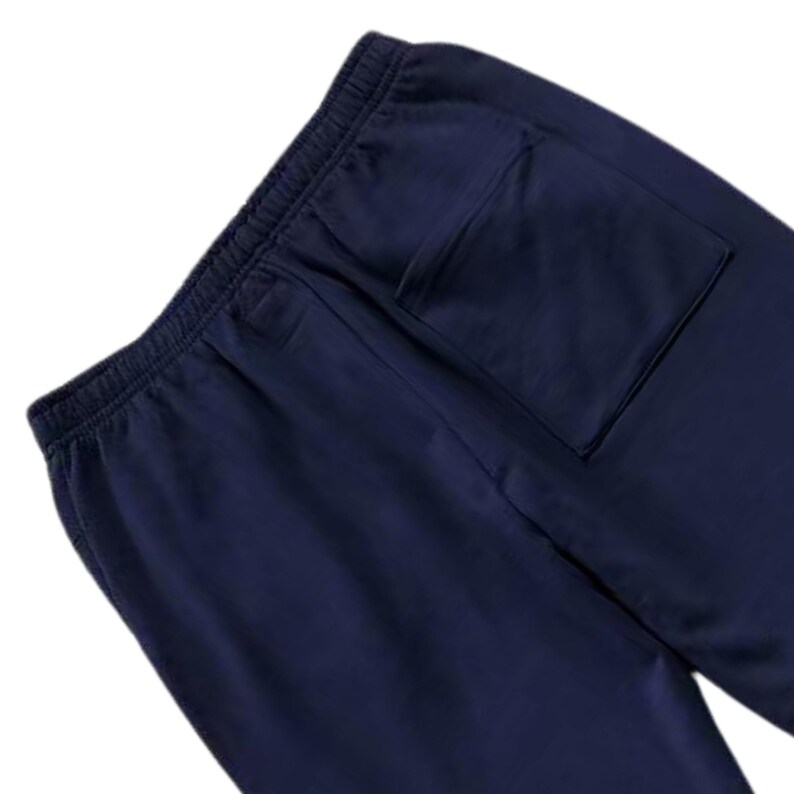 May include: Navy blue sweatpants with an elastic waistband and a single back pocket. The pants are made of a soft, comfortable material, perfect for casual wear or lounging.