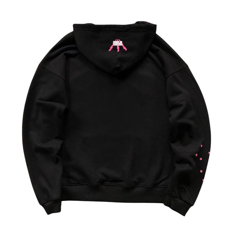 May include: Black hooded sweatshirt with pink star accents on the left sleeve and a pink graphic on the hood. The sweatshirt is a casual garment, suitable for everyday wear.