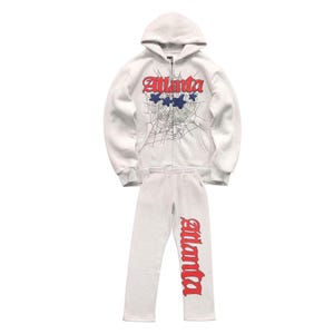 May include: A light grey zip-up hoodie and matching sweatpants set. The hoodie features the word "Atlanta" in red script with blue stars and a spiderweb design. The sweatpants have "Atlanta" in red script.