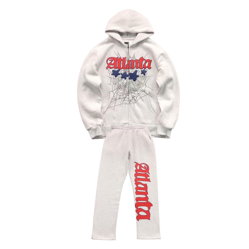 May include: A light grey zip-up hoodie and matching sweatpants set. The hoodie features the word "Atlanta" in red script with blue stars and a spiderweb design. The sweatpants have "Atlanta" in red script.