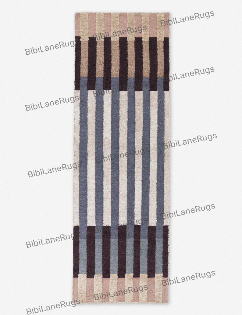 May include: A rectangular rug with vertical stripes in shades of beige, blue, and brown. The rug features a repeating pattern of varying widths, creating a textured appearance. The rug is suitable for a hallway or entryway.