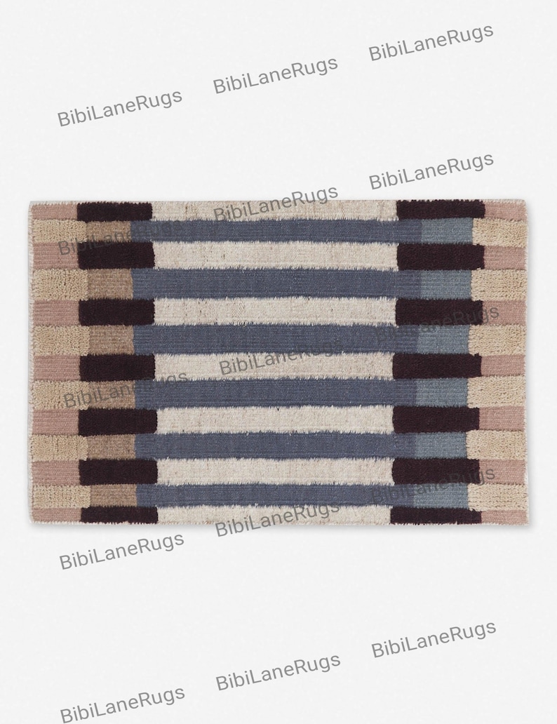 May include: Rectangular rug with a striped pattern in beige, blue, and brown. The rug has alternating horizontal stripes of varying widths and textures, creating a textured appearance. Suitable for indoor use, it measures approximately 120 cm x 180 cm.