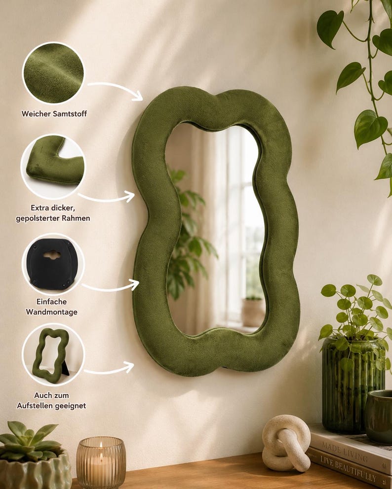 May include: An olive green, wavy-shaped wall mirror featuring a soft, plush velvet-covered frame. The design includes a thick, padded border and a rear mounting bracket for wall installation, along with a stand for tabletop display options.
