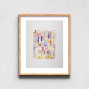 May include: A framed wall art print featuring a central rectangular composition of vertical columns made of small, multicolored horizontal dashes in shades of yellow, orange, red, purple, blue, and green against a plain white background.