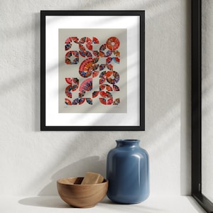 May include: Abstract art print in a black frame. The artwork features a colorful geometric design with red, orange, and blue fan-like shapes. A wooden bowl with two rectangular objects and a blue vase are on a white shelf.