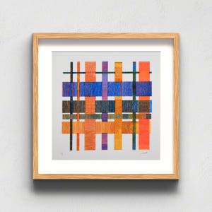 May include: A square framed art print featuring a grid of intersecting vertical and horizontal lines in vibrant shades of orange, blue, purple, yellow, and black. The composition creates a woven effect against a light gray background.