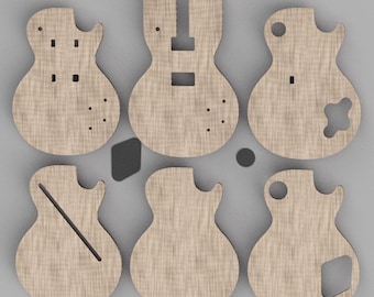 May include: Six flat, light-colored wooden guitar body cutouts arranged in two rows of three. Each piece features distinct laser-cut shapes, including circular holes, rectangular slots, and angled lines, representing various electric guitar designs.