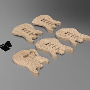 May include: Five unfinished light brown wooden electric guitar bodies with a visible wood grain pattern, arranged in a cluster. Each body features pre-cut cavities for pickups and bridge components. A small black icon is positioned to the left.