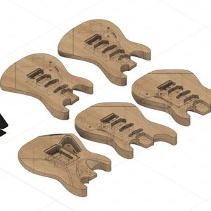 May include: Five unfinished light brown wooden electric guitar bodies with routed cavities for pickups and bridges, arranged in a cluster. A small black rectangular template with a rounded corner is positioned to the left of the guitar bodies.