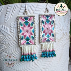 May include: A pair of rectangular beaded earrings featuring a geometric pattern in shades of pink, blue, green, and white. The earrings are finished with a fringe of white beads and small blue beads at the bottom, suspended from silver-toned hooks.