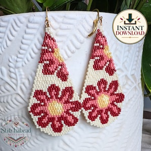 May include: A pair of teardrop-shaped beaded earrings featuring a floral pattern in shades of cream, light pink, and dark red. The earrings are constructed from small, uniform beads and include gold-toned metal ear wires for attachment.