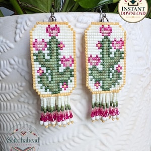 May include: Rectangular beaded earrings featuring a green cactus design with pink flowers on a white background, framed by yellow beads. The earrings include a fringe of white, green, and pink beads at the bottom and silver-tone hooks.