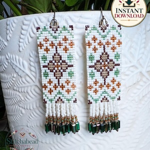 May include: A pair of rectangular beaded earrings featuring a white background with geometric patterns in green, brown, and metallic copper. The earrings have a fringe of white beads ending in dark green cylindrical beads and metal hooks.