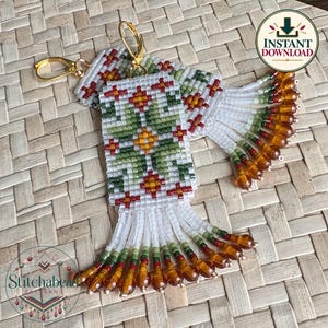 May include: A pair of rectangular beaded earrings featuring a white background with a geometric floral pattern in green, orange, and red. The earrings have gold-tone ear wires and a fringe bottom finished with translucent amber-colored beads.
