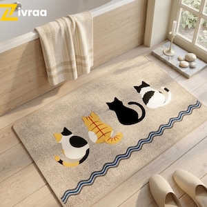 Op de afbeelding: Set van drie keramische mokken met een gespikkelde, matte afwerking. De mokken zijn in crème, lichtgrijs en donkergrijs. Elk heeft een eenvoudig, minimalistisch ontwerp.