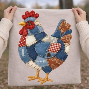 May include: A square beige fabric panel featuring a central applique of a chicken constructed from various patches of blue denim, red and white polka dot fabric, red plaid, and brown floral print, accented with two brown buttons and a yellow beak.