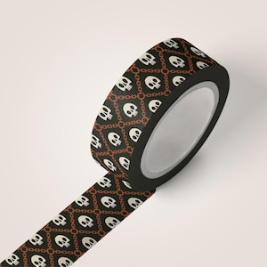 May include: A roll of decorative washi tape featuring a repeating pattern of white skulls and brown chain links on a black background. The tape is unrolled, revealing the design. Perfect for scrapbooking and crafting projects.