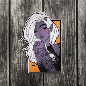 May include: A sticker featuring a purple-skinned woman with long white hair, wearing a black tank top with a skull and floral design. The background is orange.