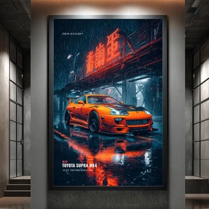 May include: A framed vertical poster featuring an orange Toyota Supra MK4 parked on a wet city street at night. The scene includes red neon Japanese text above the car, rain, and reflections on the ground. Text reads TOKYO DIVISION and TOYOTA SUPRA MK4.