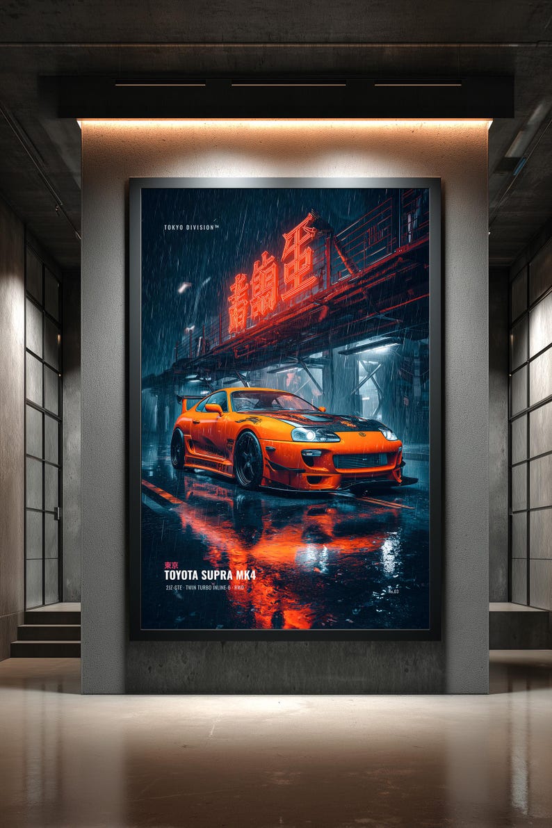 May include: A framed vertical poster featuring an orange Toyota Supra MK4 parked on a wet city street at night. The scene includes red neon Japanese text above the car, rain, and reflections on the ground. Text reads TOKYO DIVISION and TOYOTA SUPRA MK4.