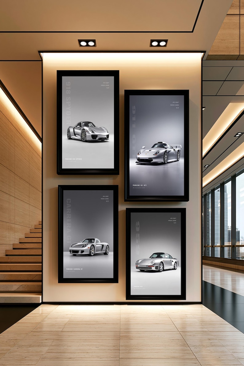 May include: Four rectangular black-framed wall posters displayed on a light-colored wall. Each poster features a silver Porsche sports car on a gray background with white text identifying the specific model, including 918 Spyder and Carrera GT.