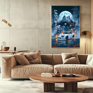May include: A vertical wall poster titled LAST FUEL featuring a white Toyota Supra sports car parked at a petrol station under a large full moon. The scene includes orange pumpkins, utility poles, and wet pavement reflecting the blue and white light.