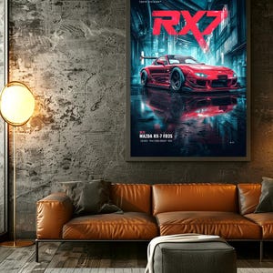 May include: A framed wall poster featuring a red Mazda RX-7 FD3S sports car parked on a wet city street at night. The text RX7 is displayed in large red letters at the top, with Tokyo Division and Mazda RX-7 FD3S printed in smaller white text.
