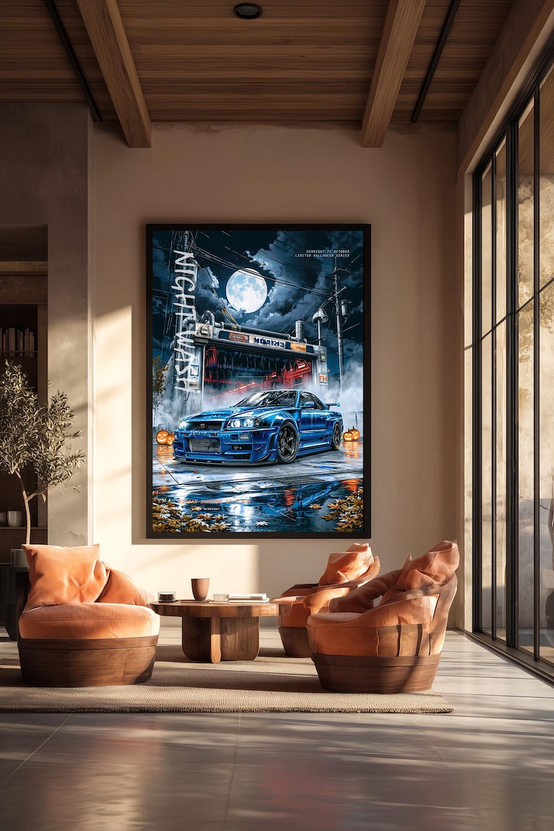 May include: A framed wall art print featuring a blue sports car parked in front of a car wash at night under a full moon. The scene includes orange pumpkins, fallen autumn leaves, and the vertical text NIGHT WASH in white lettering.