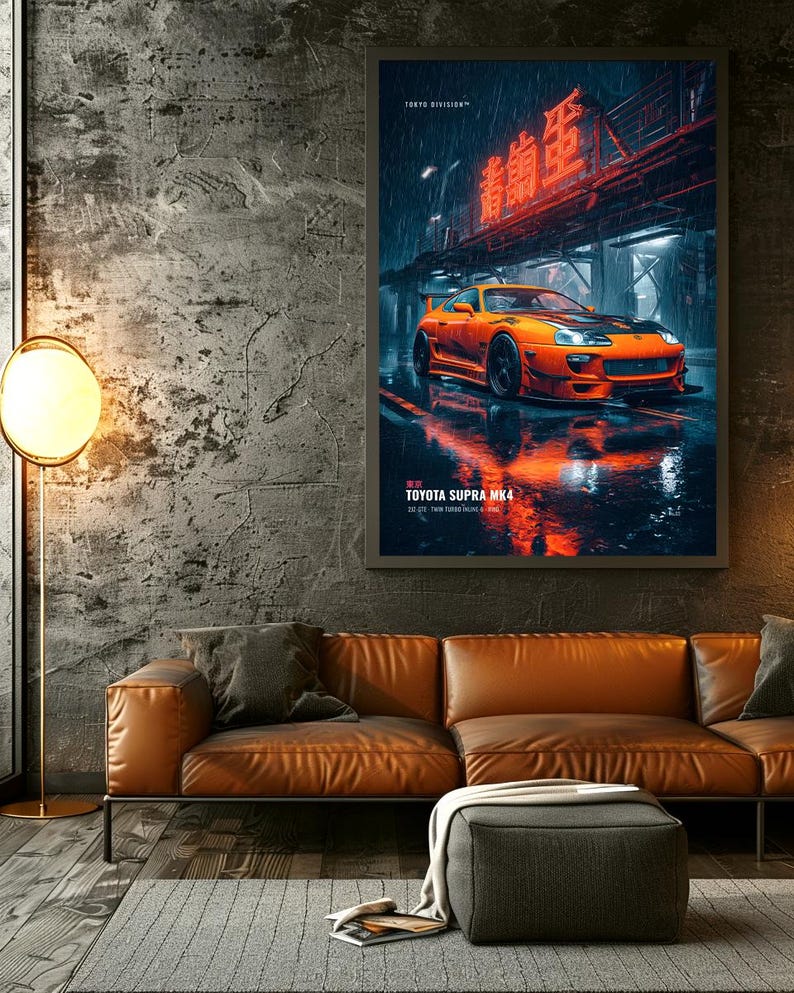 May include: A framed vertical wall art print featuring an orange Toyota Supra MK4 sports car parked on a wet city street at night. The image includes red neon Japanese text, the text TOKYO DIVISION, and TOYOTA SUPRA MK4 2JZ-GTE TWIN TURBO.