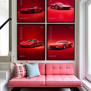 May include: Four framed posters featuring red Ferrari sports cars displayed on a wall above a pink tufted bench. The posters are labeled Competizione, Daytona, Enzo, and Testarossa. The bench has two throw pillows, one red plaid and one light blue.