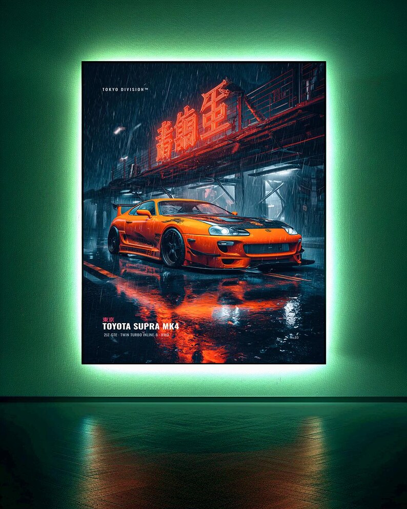 May include: A rectangular wall art print featuring an orange Toyota Supra MK4 parked on a wet city street at night. The scene includes red neon kanji signage, rain, and reflections. Text reads TOKYO DIVISION, TOKYO, TOYOTA SUPRA MK4, 2JZ-GTE.