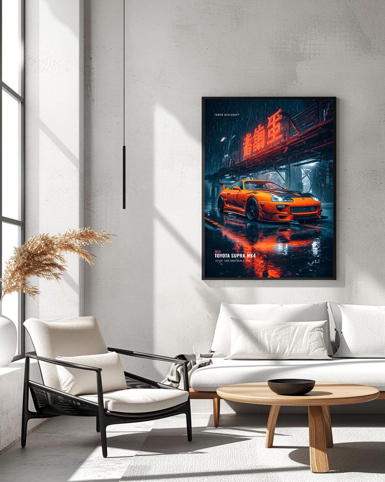 May include: A framed wall art print featuring an orange Toyota Supra MK4 parked on a wet city street at night. The scene includes neon red Japanese text above the car, rain-slicked pavement with reflections, and the text TOYOTA SUPRA MK4 below.