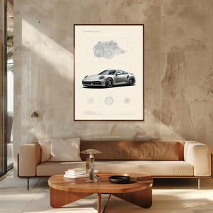 Puede incluir: Una l&aacute;mina art&iacute;stica enmarcada que muestra un coche deportivo plateado bajo un plano t&eacute;cnico de un motor. La impresi&oacute;n incluye el texto ENGINEERING ICON en la parte superior y 911 TURBO S en la inferior, con tres iconos circulares de ruedas.