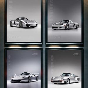 May include: A set of four framed posters featuring silver Porsche sports cars. The prints display the 918 Spyder, Carrera GT, 911 GT1, and 959 models, each labeled with its name and the text Apex Icons Porsche Legends.