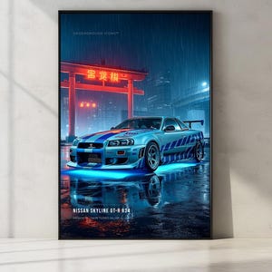 May include: A framed vertical poster featuring a silver Nissan Skyline GT-R R34 with blue racing stripes parked under a red torii gate at night in the rain. The car has bright blue underglow lighting and is reflected on the wet ground. Text reads UNDERGROUND ICONS and NISSAN SKYLINE GT-R R34.