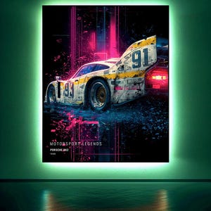 May include: A rectangular wall art piece featuring a Porsche 962 race car with the number 91 and 93 visible. The design includes vibrant pink and blue light streaks against a dark background, with the text MOTORSPORT LEGENDS PORSCHE 962 1988.