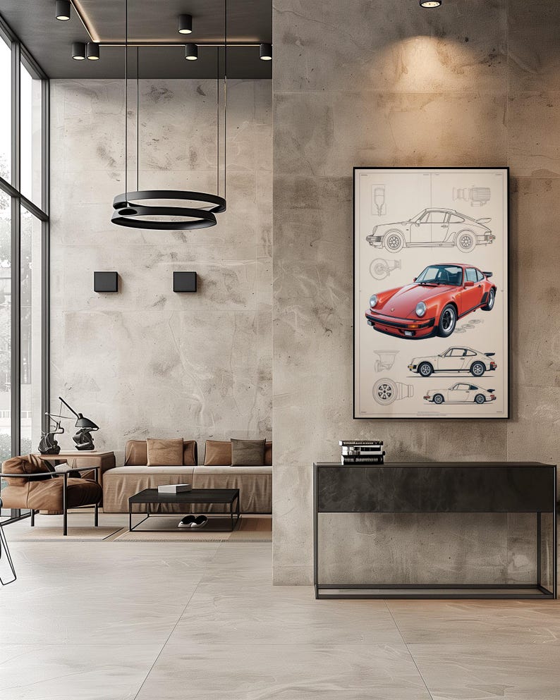 Puede incluir: Un cuadro enmarcado que presenta una ilustraci&oacute;n de un coche deportivo rojo centrado entre dibujos t&eacute;cnicos de l&iacute;neas del mismo veh&iacute;culo en perfiles laterales y superiores, expuesto en una pared de hormig&oacute;n gris claro sobre una consola.