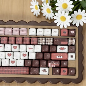 May include: A white ceramic mug with a black handle and the text "But First, Coffee" in a handwritten style. The mug is on a white surface. The mug is approximately 4 inches tall.