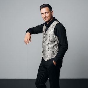 May include: A white ceramic mug with a black handle and the text "But First, Coffee" in a black, bold font. The mug is sitting on a wooden surface. The mug is approximately 4 inches tall.