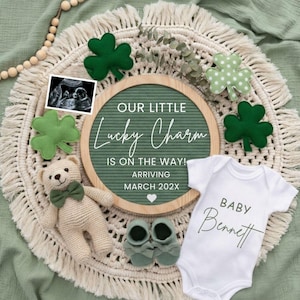 May include: A baby announcement with a green and cream color scheme. The announcement includes a letter board with the text "OUR LITTLE Lucky Charm IS ON THE WAY! ARRIVING MARCH 202X". A white onesie with the name "Bennett" is also included.