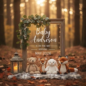 May include: A baby announcement with the text "Baby Andreson is on the way, arriving May 2026." The announcement is framed with greenery and fairy lights. Plush toys of a bear, deer, rabbit, and fox sit on a blanket. A lantern with a lit candle is on the left.