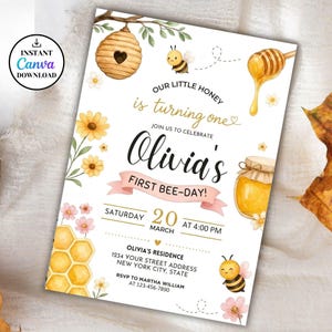May include: A bee-themed first birthday invitation with watercolour illustrations. The design includes a beehive, honey, and bees, with floral accents. The text reads "Our Little Honey is turning one" and "Olivia's First Bee-Day!" with event details.