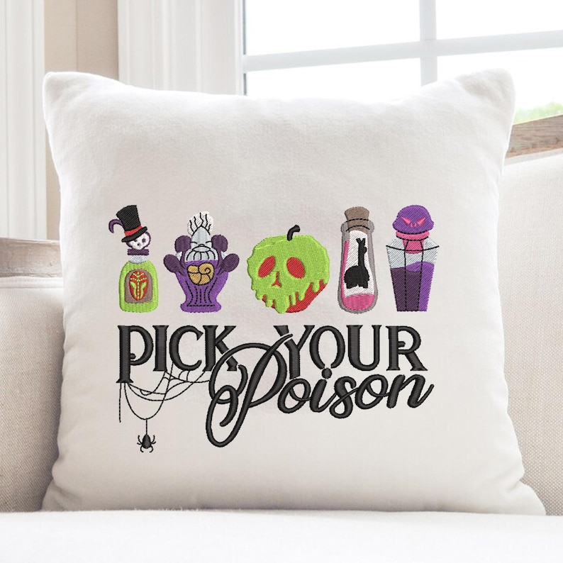 May include: White square pillow with embroidered Halloween-themed designs. Features colorful potion bottles, a skull, and the text "PICK YOUR POISON" in black script. A spider and web are also embroidered below the text.