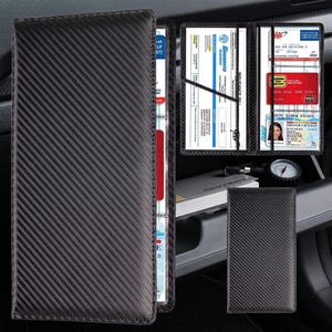 May include: Black carbon fiber textured car document holder. The open holder displays a driver's license, insurance card, and other documents. A smaller matching wallet is also visible.