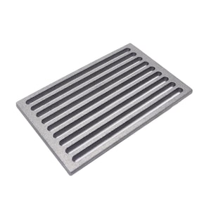 May include: A rectangular, grey metal grate with parallel slots. The grate is designed for drainage or ventilation. The metal has a slightly rough texture, and the slots run the length of the rectangle.