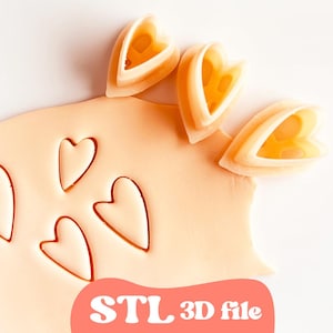 May include: A close-up of a light orange clay with heart-shaped cutouts and heart-shaped cutters. The text "STL 3D file" is in a red rounded rectangle at the bottom. The cutters are light orange and have a heart shape.