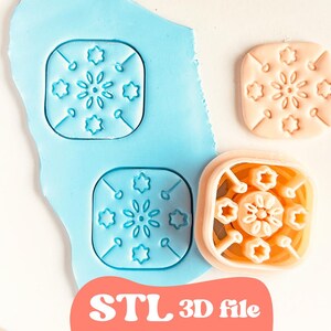 May include: A light blue polymer clay with two impressions of a square floral design. A peach-colored impression and a 3D printed orange cutter with the same design are also present. The text "STL 3D file" is at the bottom.